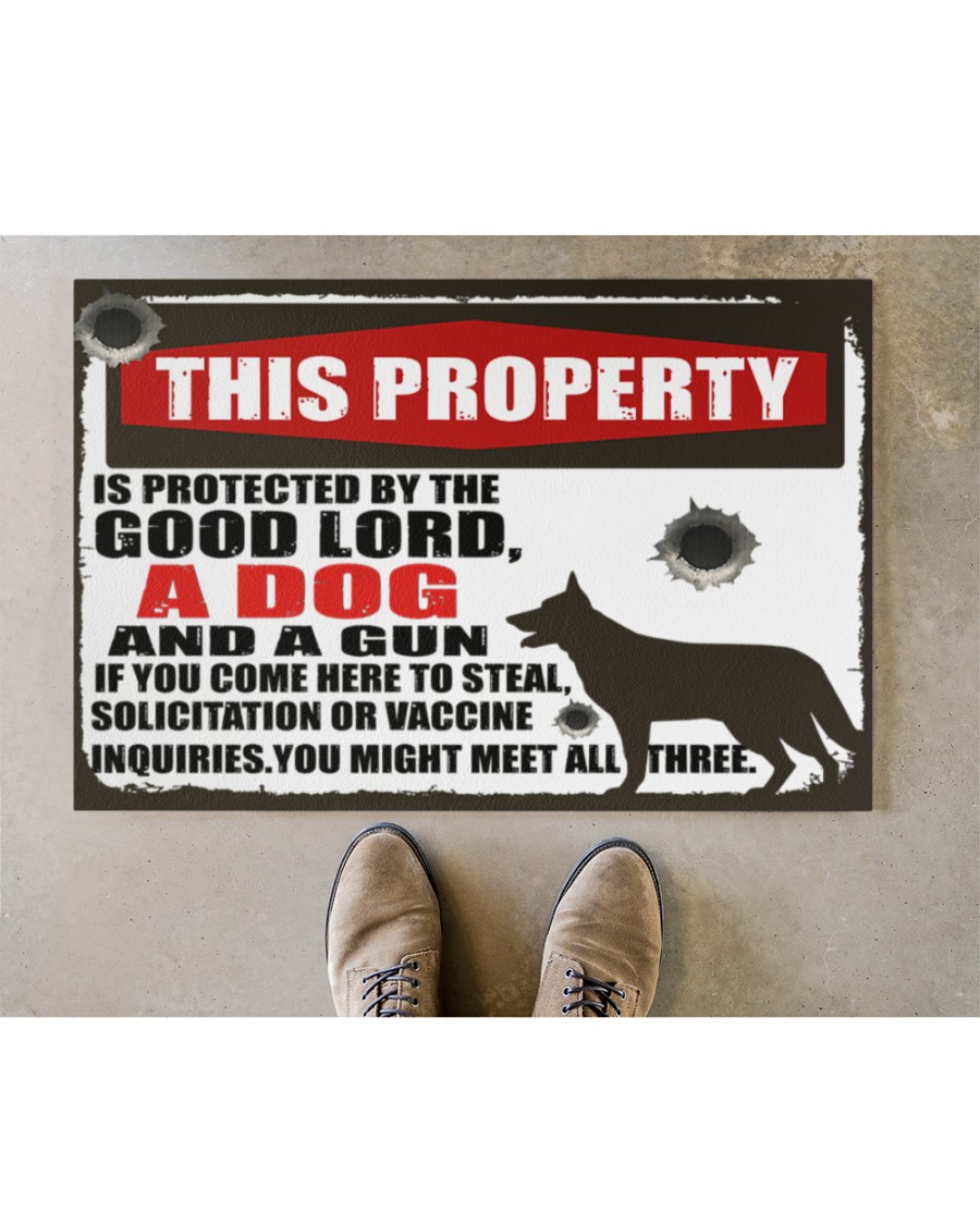 This property is protected by the good lord and a gun doormat and yard sign